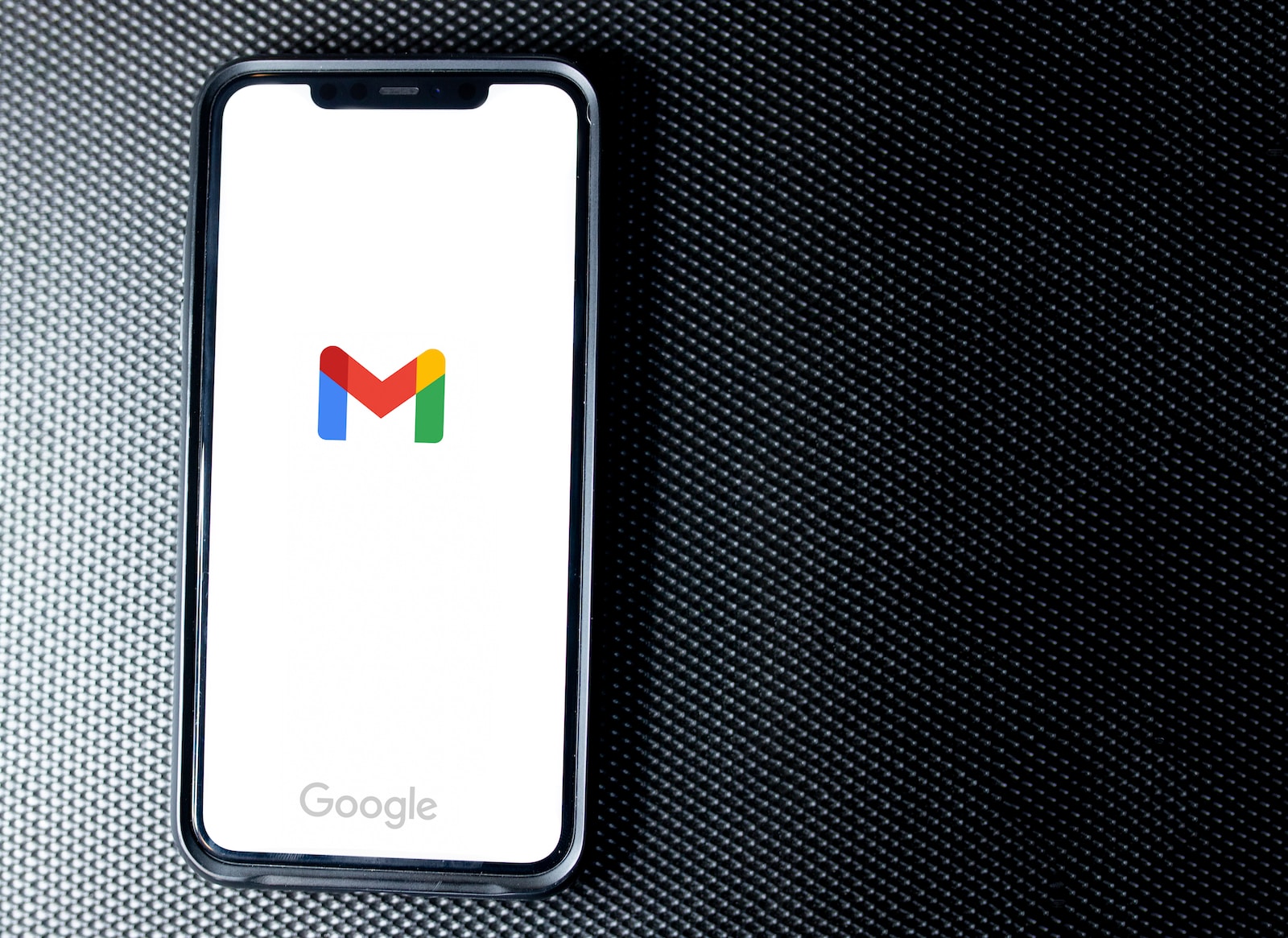 black samsung android smartphone on black textile